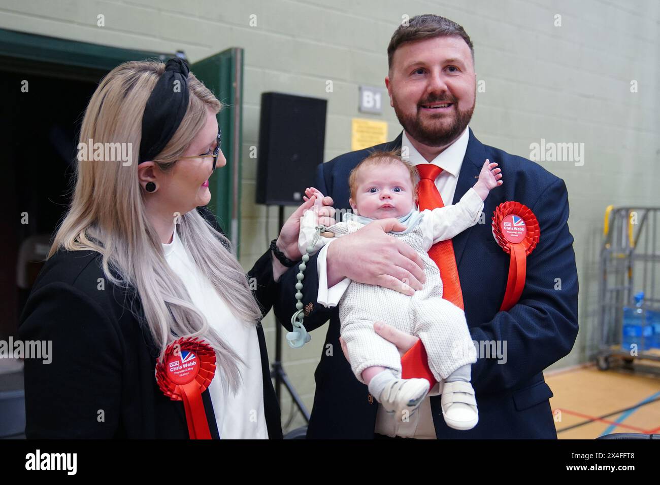 Labour candidate Chris Webb celebrates with his wife Portia and baby Cillian Douglas Webb after winning the Blackpool South by-election following the count at Blackpool Sports Centre, Blackpool. The by-election was triggered after the resignation of Scott Benton. Picture date: Friday May 3, 2024. Stock Photo