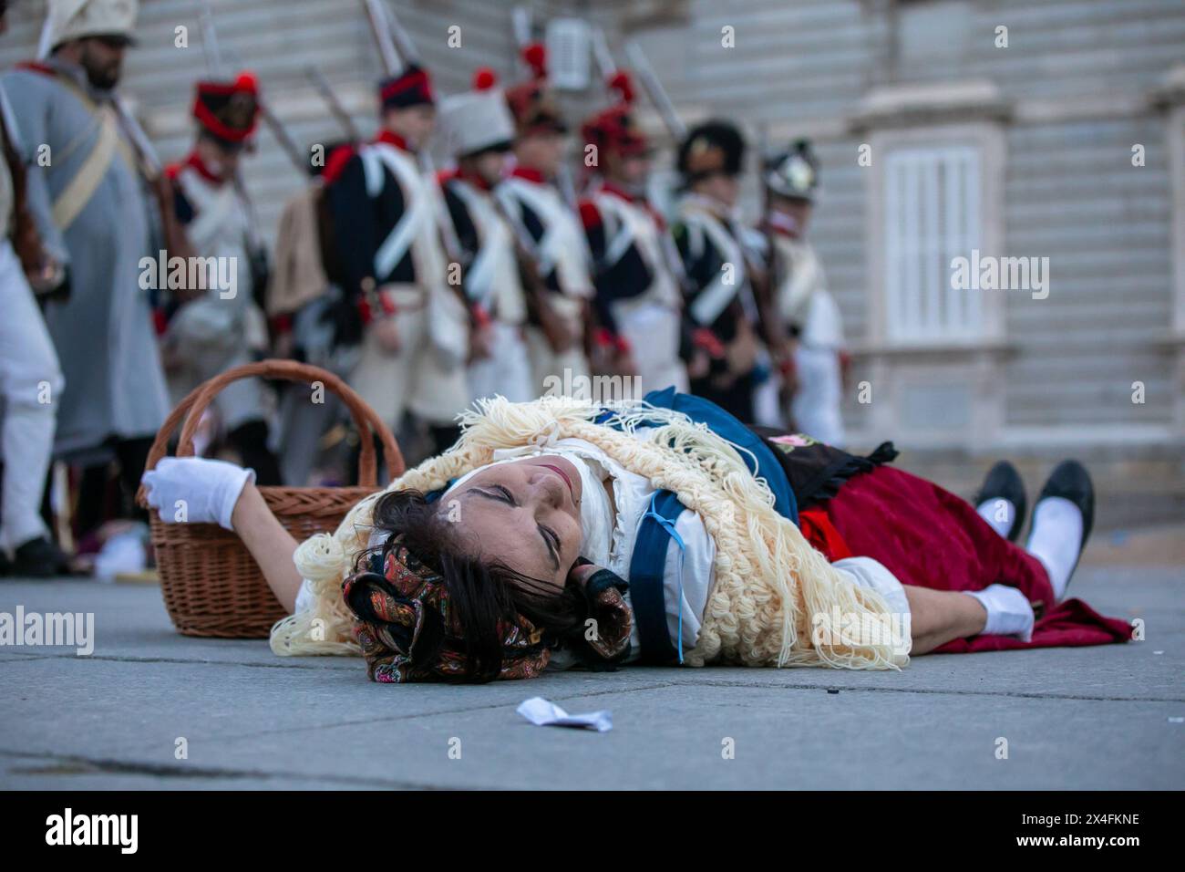 An extra recreates having fallen in combat during an artistic performance in the center of Madrid. May 2, 1808 marked a milestone in the history of Madrid, when its people rose up against the French troops, defying the orders of King Charles IV and Ferdinand VII not to attack the invaders. The Historical Cultural Association 'Volunteers of Madrid 1808-1814' one more year on the occasion of the Day of the Community of Madrid has recreated in the center of Madrid the battles of the War of Independence against the Napoleonic troops that had invaded Spanish territory between 1808 and 1814. Stock Photo