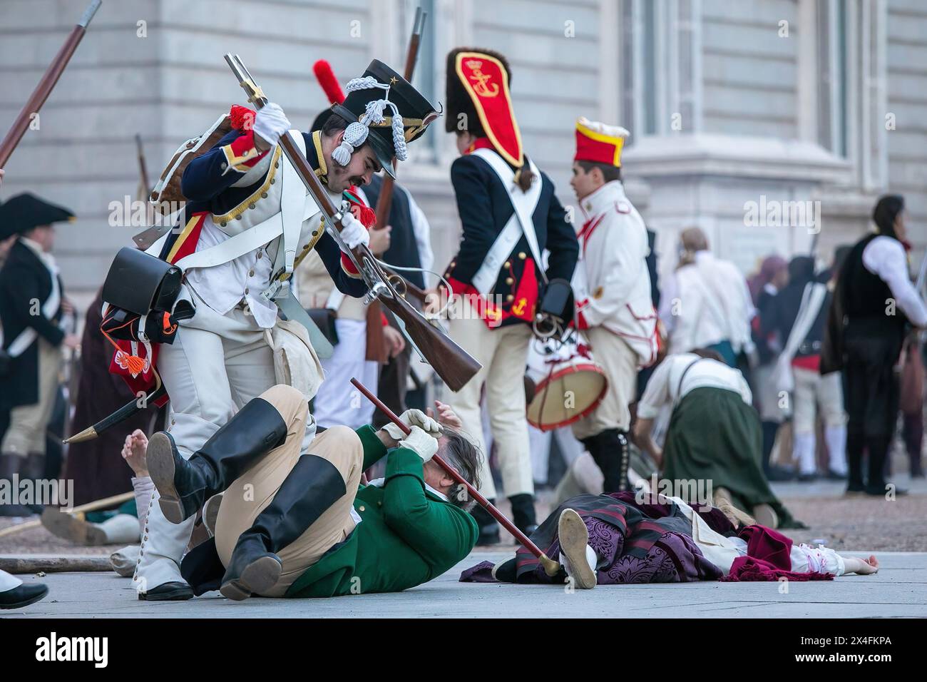 A group of extras recreate a battle during an artistic performance in the center of Madrid. May 2, 1808 marked a milestone in the history of Madrid, when its people rose up against the French troops, defying the orders of King Charles IV and Ferdinand VII not to attack the invaders. The Historical Cultural Association 'Volunteers of Madrid 1808-1814' one more year on the occasion of the Day of the Community of Madrid has recreated in the center of Madrid the battles of the War of Independence against the Napoleonic troops that had invaded Spanish territory between 1808 and 1814. Stock Photo