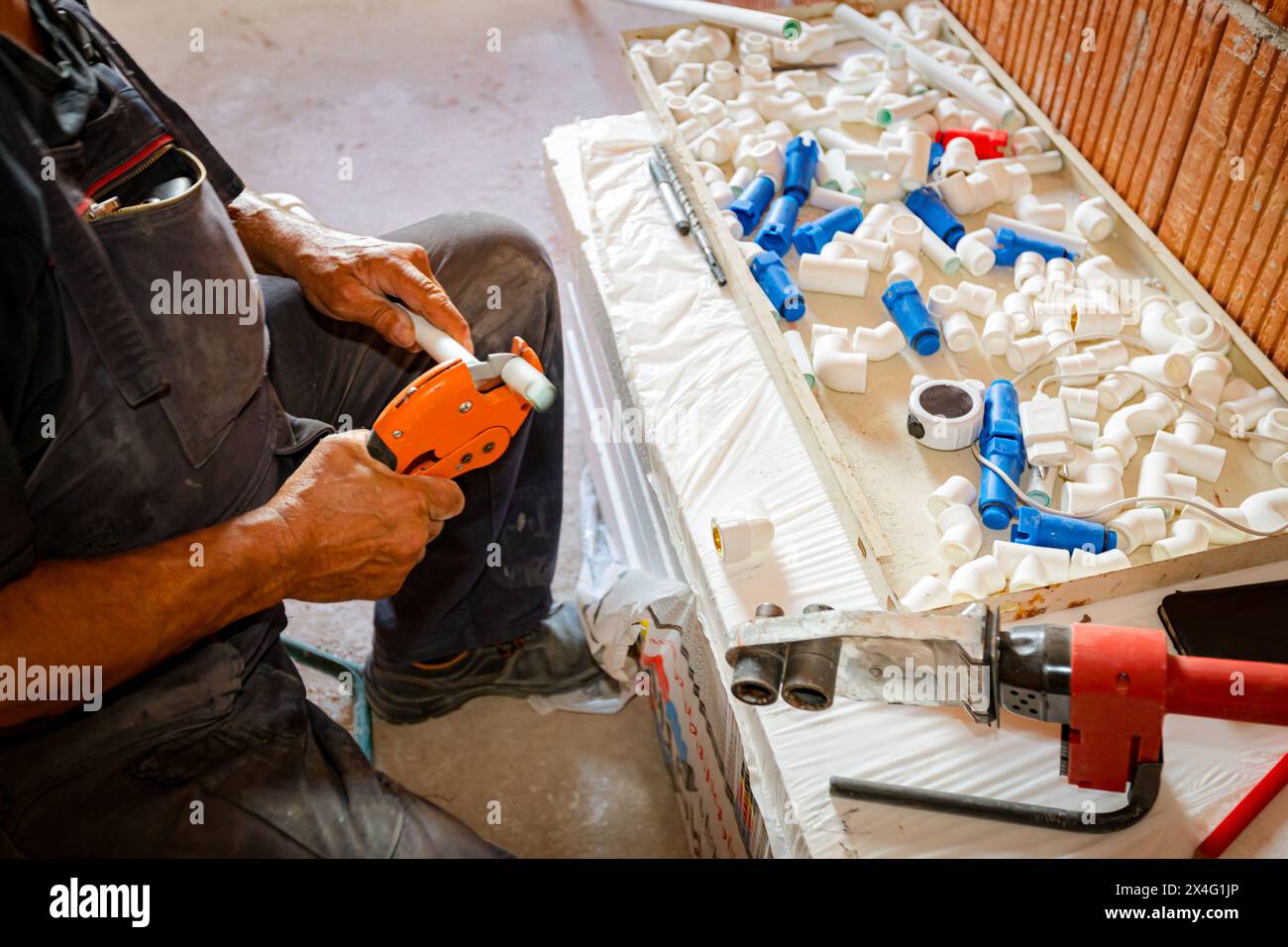 Plumber's hands as preparing polypropylene pipes to connecting them in ...