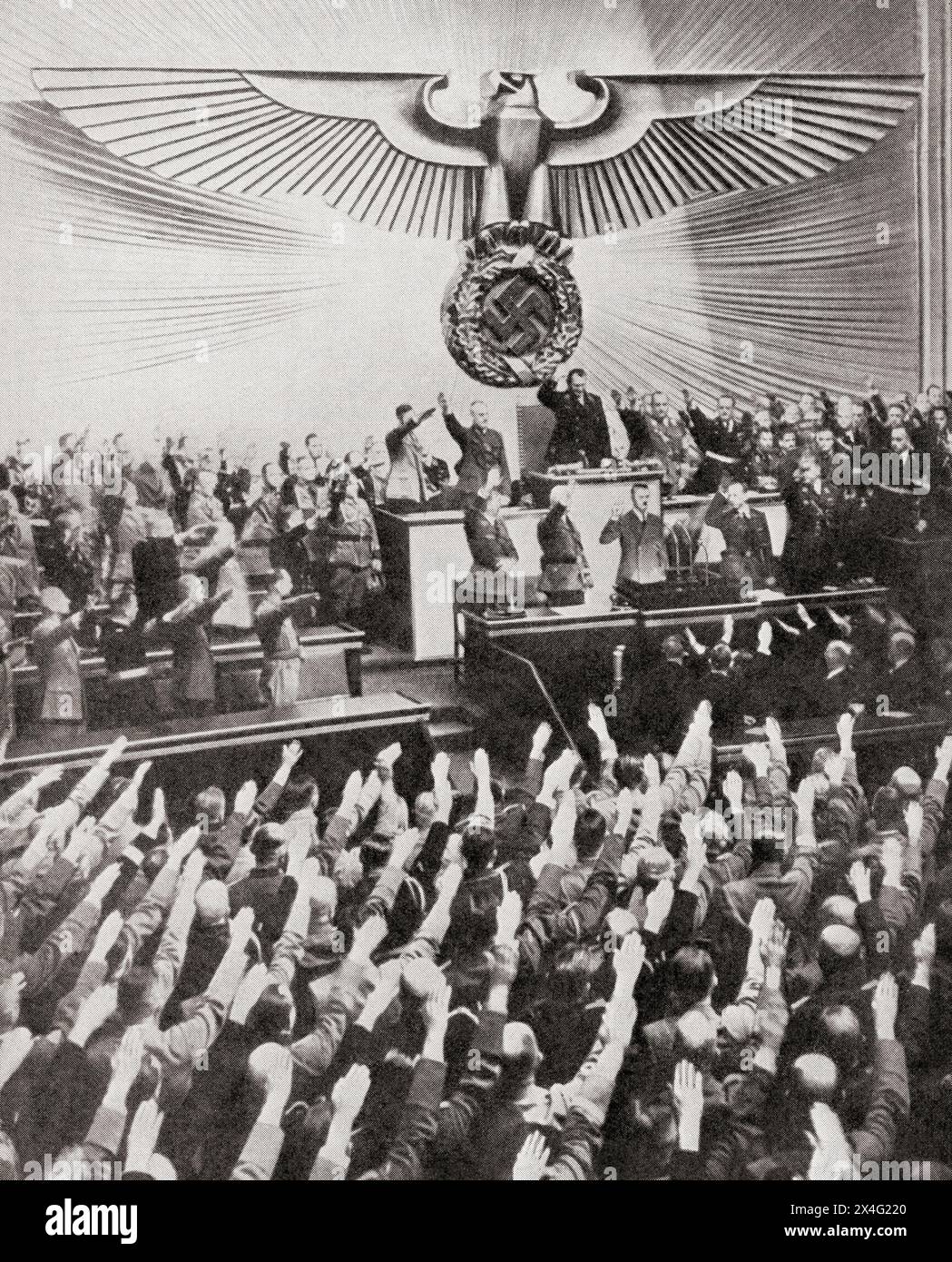 Hitler delivering his 'peace' speech in the Reichstag, 6 October 1939.  Adolf Hitler, 1889 – 1945. German politician, demagogue, Pan-German revolutionary, leader of the Nazi Party, Chancellor of Germany, and Führer of Nazi Germany from 1934 to 1945.  From The War in Pictures, First Year. Stock Photo