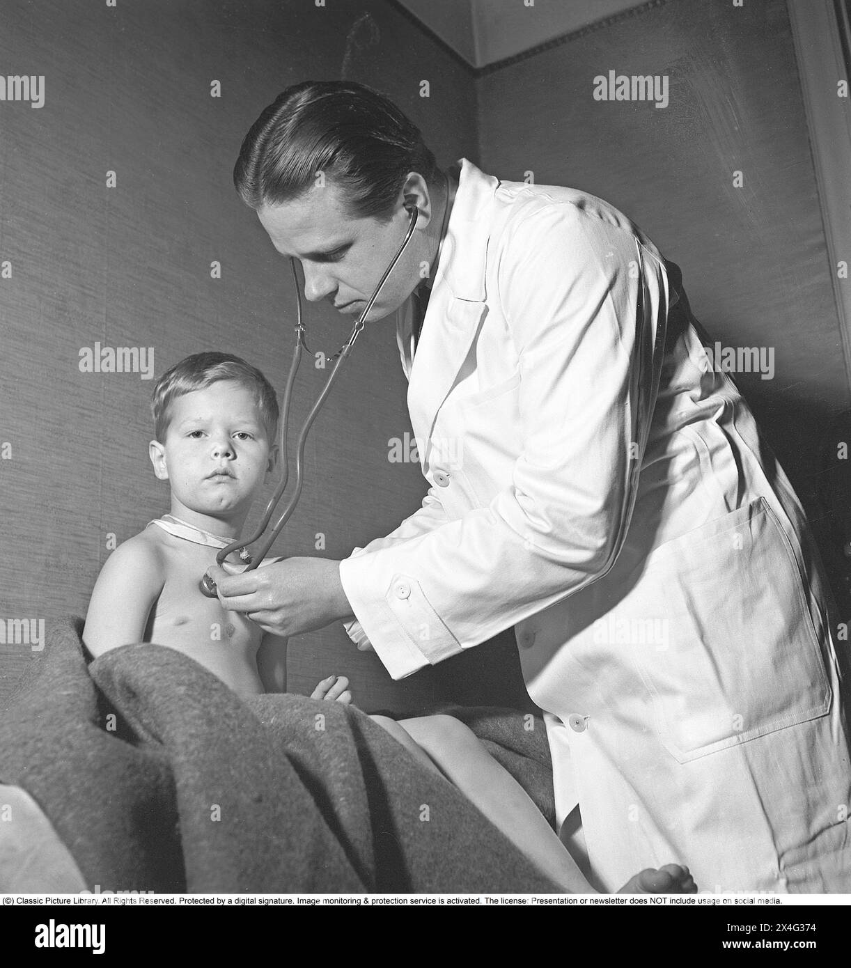 World War 2 in Europe. Finnish children in Sweden. A doctor examines a small Finnish boy with a stethoscope. The doctor has placed the note attached with a string around the neck with the boy's name on the boy's back.  In February 1944, the Finnish cities are exposed to bombings. The Finnish civilian population had to endure a lot of suffering and for that reason the evacuation of Finnish children to Sweden increased in order to put the children to safety. The children were sent from Finland to Sweden and the goal was that all children would be reunited with their relatives after the war. Many Stock Photo