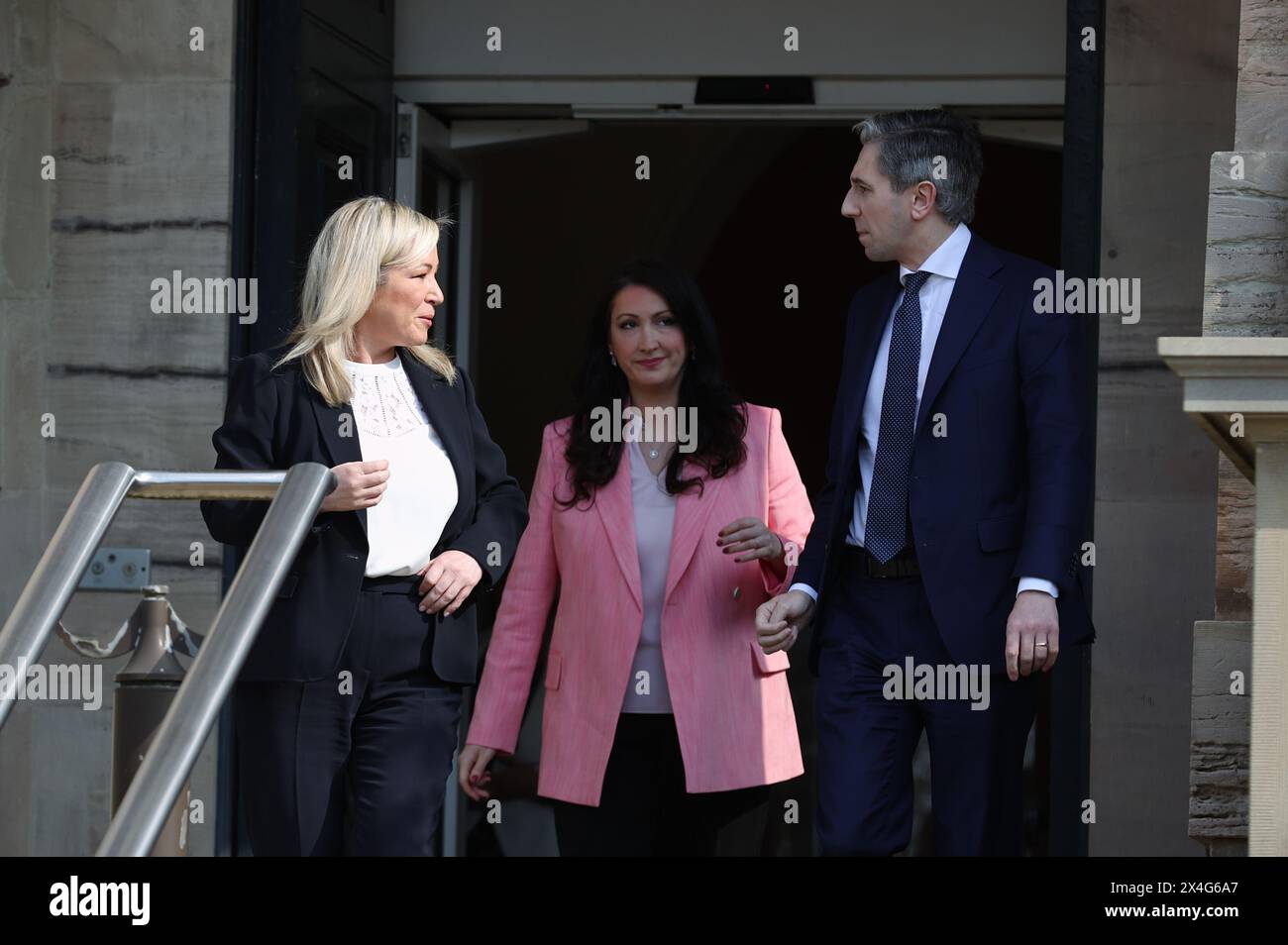 Taoiseach Simon Harris being greeted on the steps of Stormont Castle by First Minister Michelle O'Neill and deputy First Minister Emma Little-Pengelly as makes his first official visit to Northern Ireland. Picture date: Friday May 3, 2024. Stock Photo