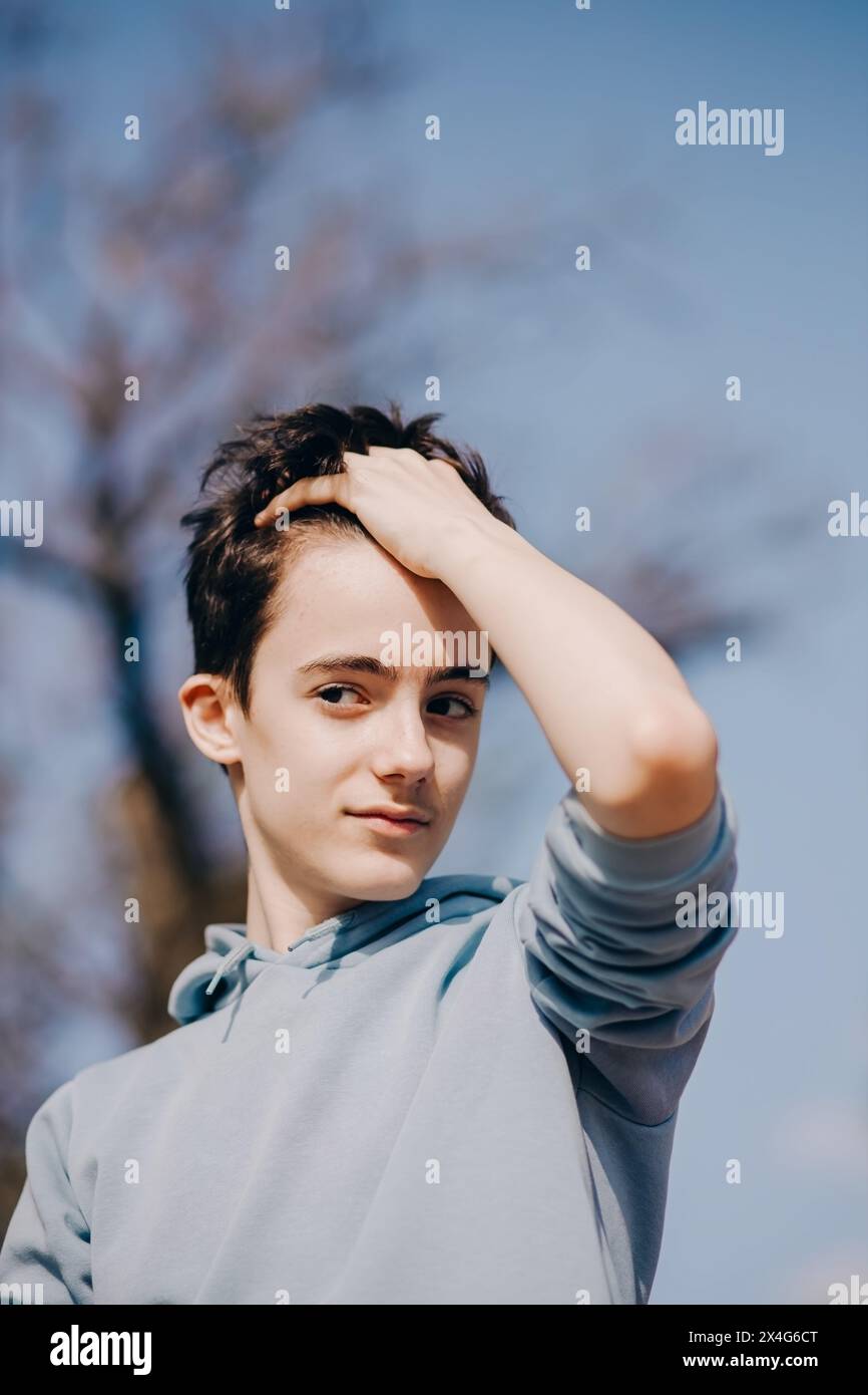 Portrait of adolescent in casual clothes at blue sky background Stock Photo