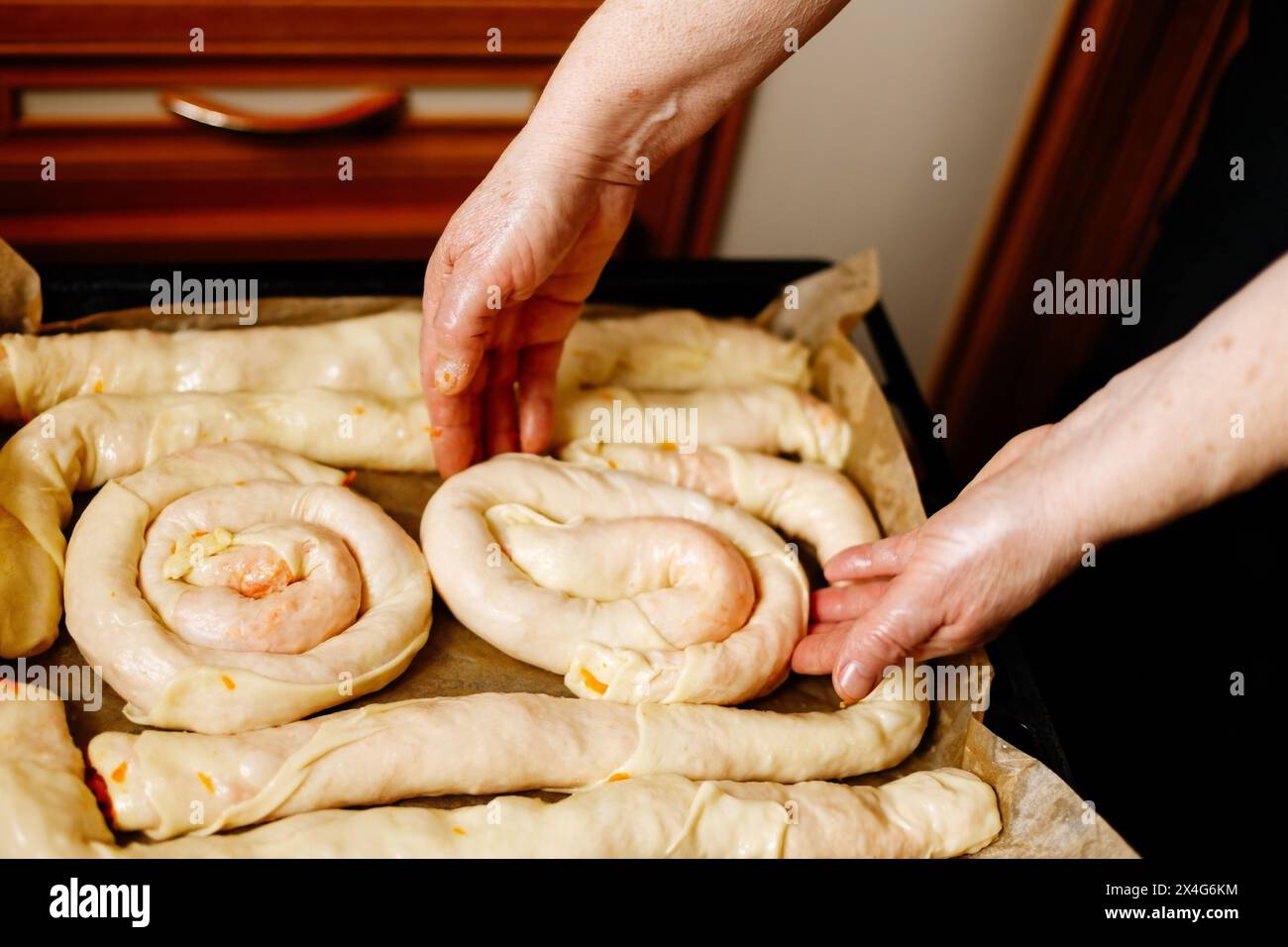 Person preparing pastries from dough with pumpkin Stock Photo