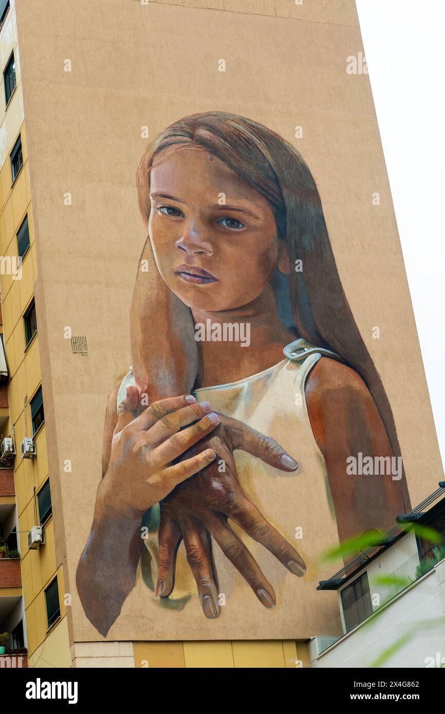 Large mural on side of apartment block about human trafficking off children, Tirana, Albania, Europe Stock Photo