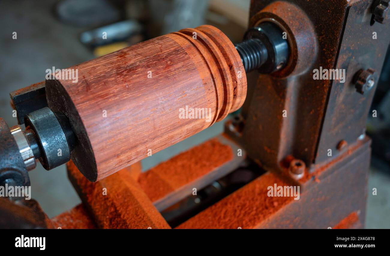 Carving redwood on a woodworking lathe Stock Photo