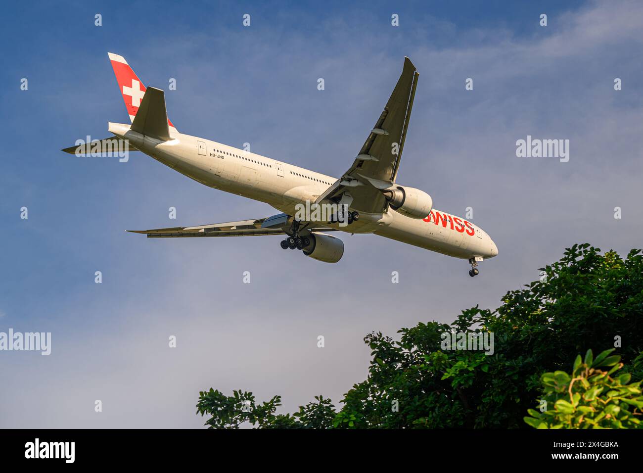 Swiss, Boeing 777-300ER, HB-JND, on final approach to Singapore Changi airport Stock Photo