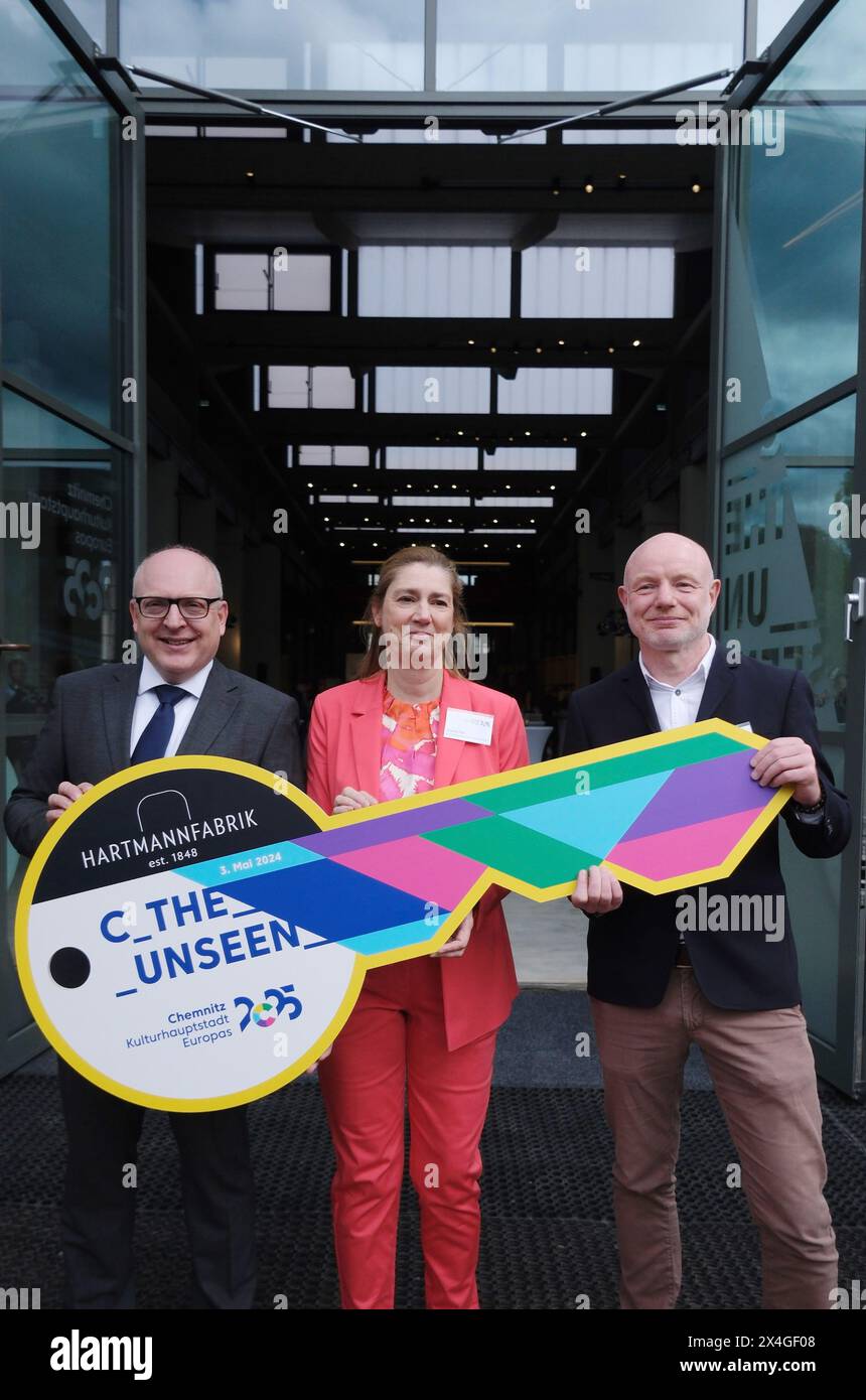 Chemnitz, Germany. 03rd May, 2024. Sven Schulze (SPD/ l-r), Lord Mayor of the City of Chemnitz, Andrea Pier, Managing Director of the European Capital of Culture Chemnitz 2025 gGmbH, and Stefan Schmidtke, Artistic Director of the event, stand in front of the former Hartmannfabrik. The visitor center will be located there for the European Capital of Culture year Chemnitz 2025. The key to the hall from 1864 was symbolically handed over. Credit: Sebastian Willnow/dpa/Alamy Live News Stock Photo