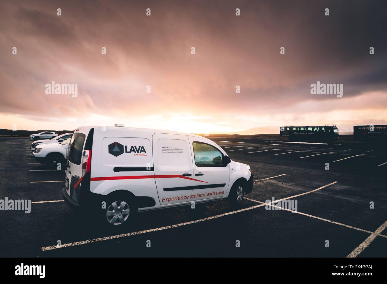 Reykjavik, Iceland - march 15th, 2023: famous budget Lava company rented white camper van stand in parking lot in Iceland with sunset background Stock Photo