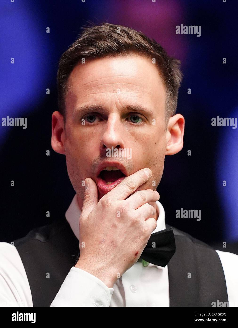 David Gilbert reacts during their semi-final match against Kyren Wilson (not pictured) on day fourteen of the 2024 Cazoo World Snooker Championship at the Crucible Theatre, Sheffield. Picture date: Friday May 3, 2024. Stock Photo