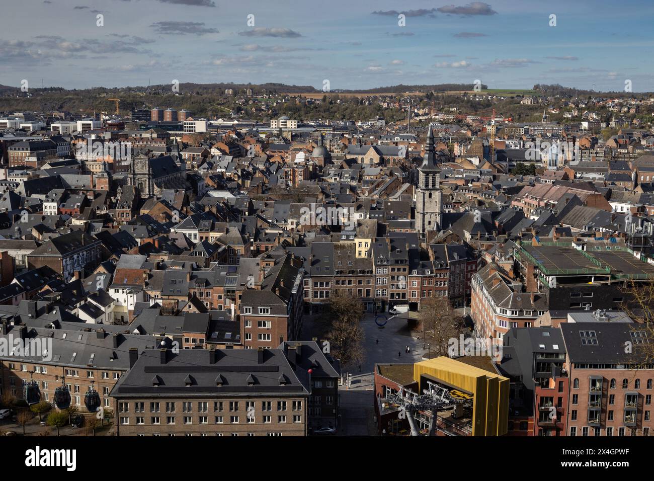 Panoramic cityscape of Namur in Wallonia, Belgium. Captured here on a spring day with a mix of modern and traditional architecture set against a blue Stock Photo