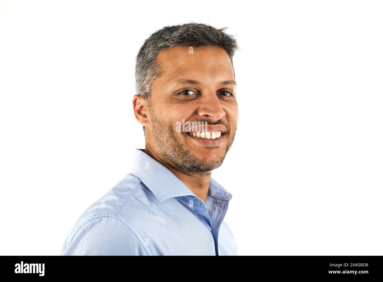 A man with a beard and gray hair is smiling for the camera Stock Photo