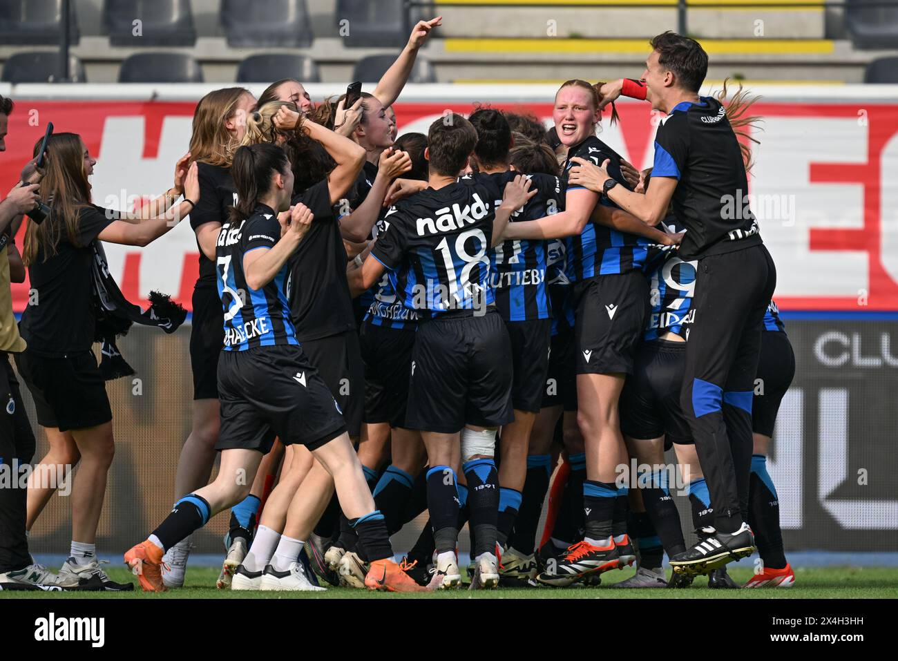 players of Club YLA celebrate after winning a female soccer game