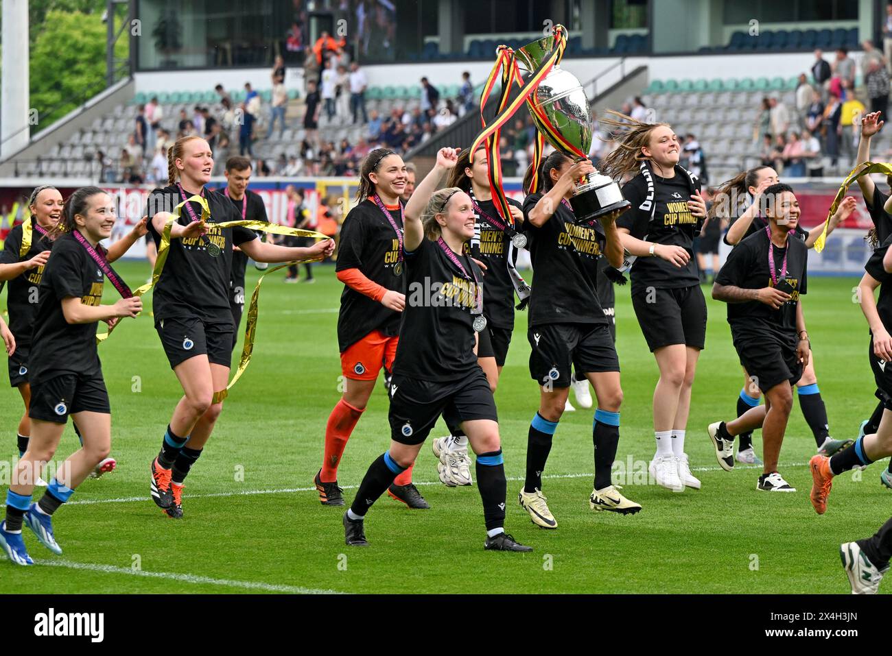 players of Club YLA celebrate after winning a female soccer game