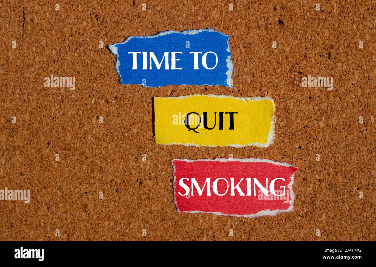 Time to quit smoking words written on ripped paper pieces with brown background. Conceptual time to quit smoking symbol. Copy space. Stock Photo