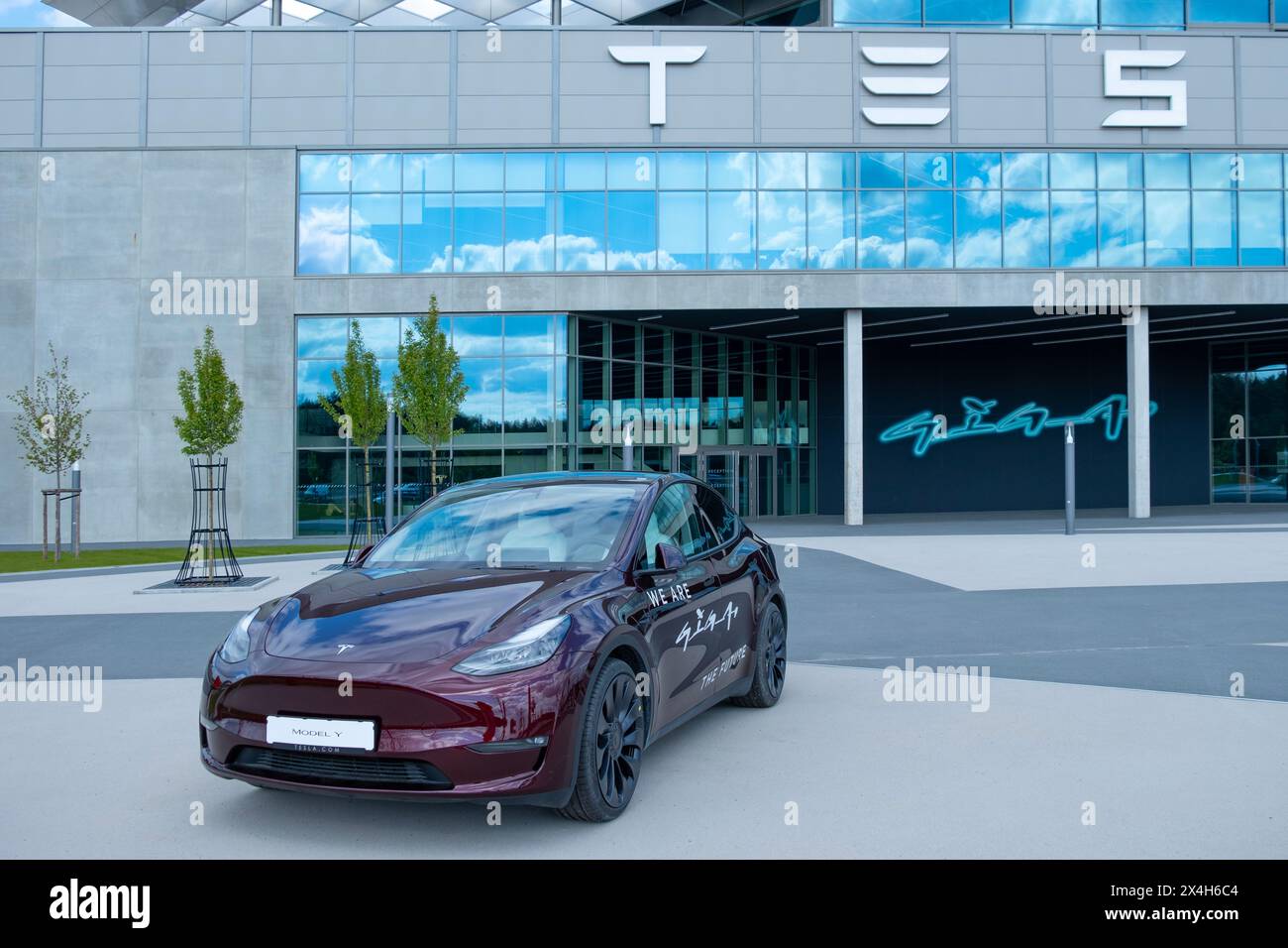 cherry red Tesla model y electric car front Gigafactory Berlin