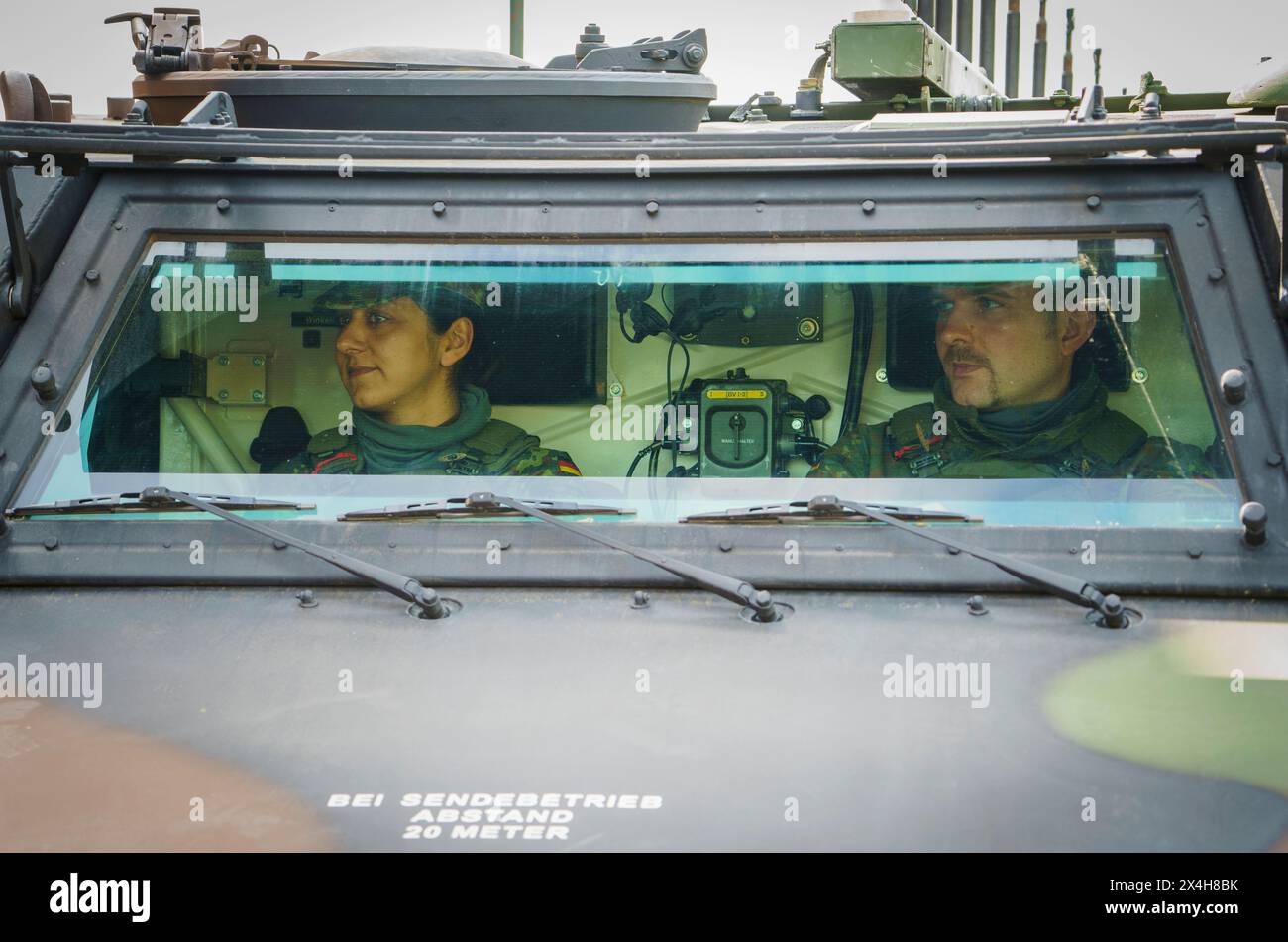 27 April 2024, Hesse, Alsfeld: Bundeswehr soldiers sit in an armored ...
