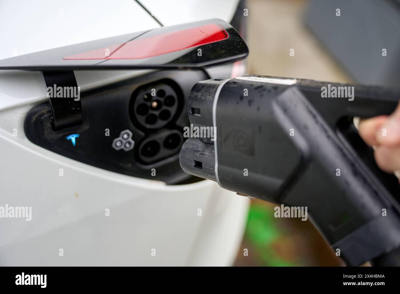 Italy 01 May Person inserts a plug or charging cable / charging plug of a charging station