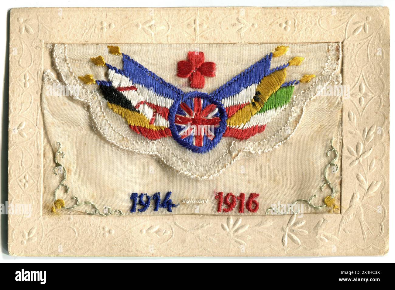 France. 1916 – An antique French-made silk postcard produced during the First World War as a souvenir for volunteers serving with the British Red Cross. The card is hand-embroidered with the Red Cross insignia above a roundel containing the Union Jack, surrounded by the flags of the other allied nations: Belgium, Japan, France, Serbia, Russia, and Italy. Below are the dates “1914-1916”. Stock Photo