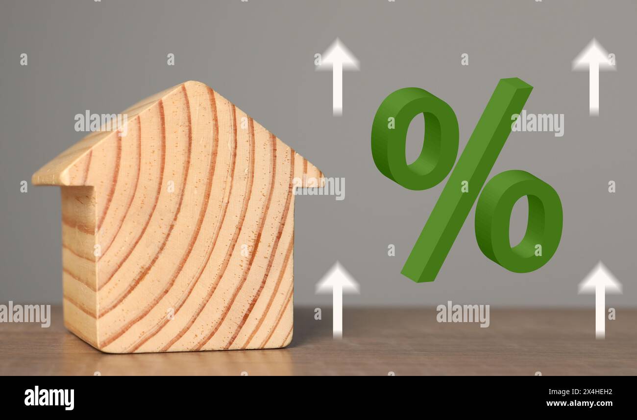 Mortgage rate. Wooden model of house, arrows and percent sign, banner ...