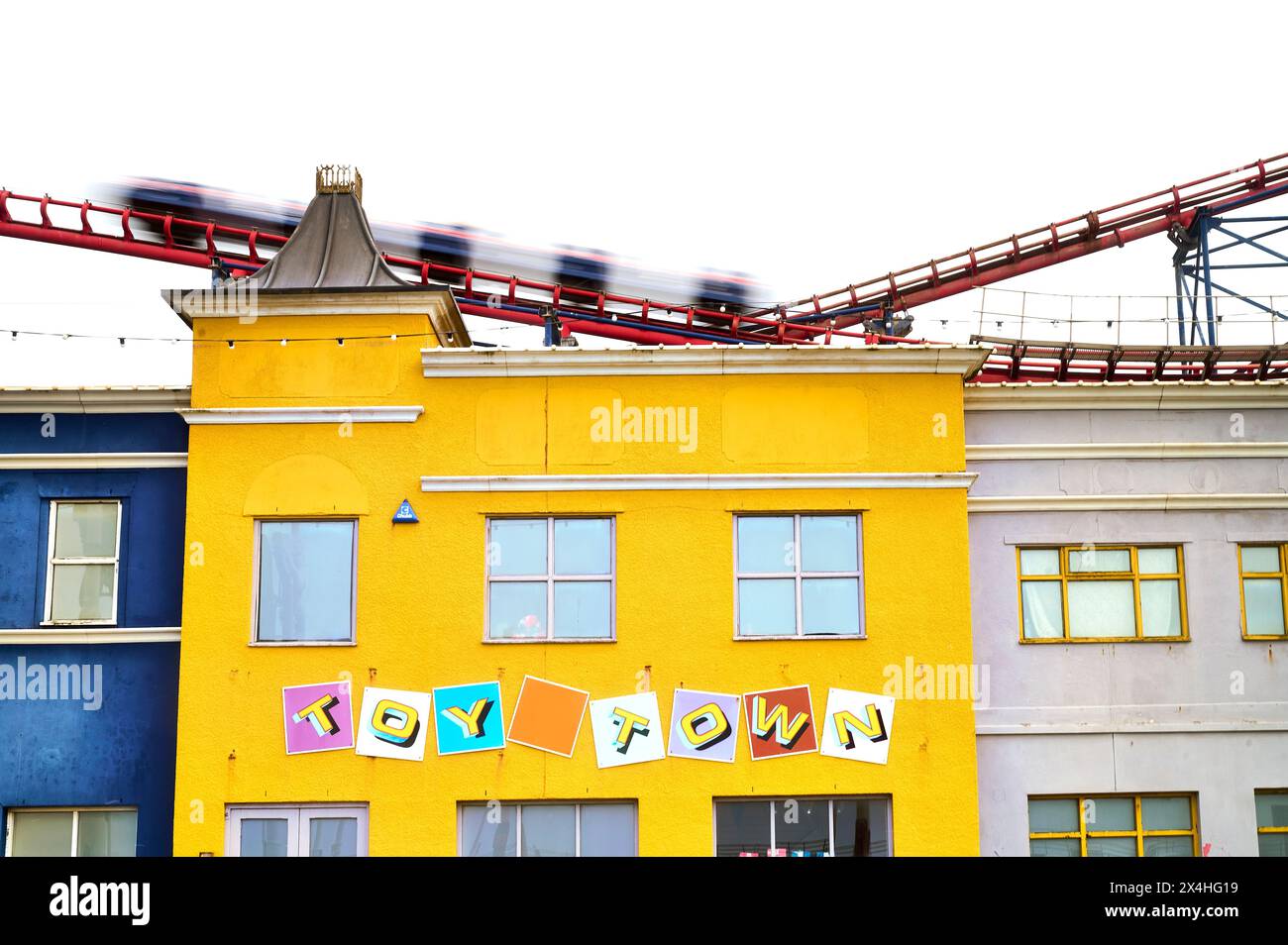 Speeding roller coaster carriages passing Toy Town shop at Blackpool