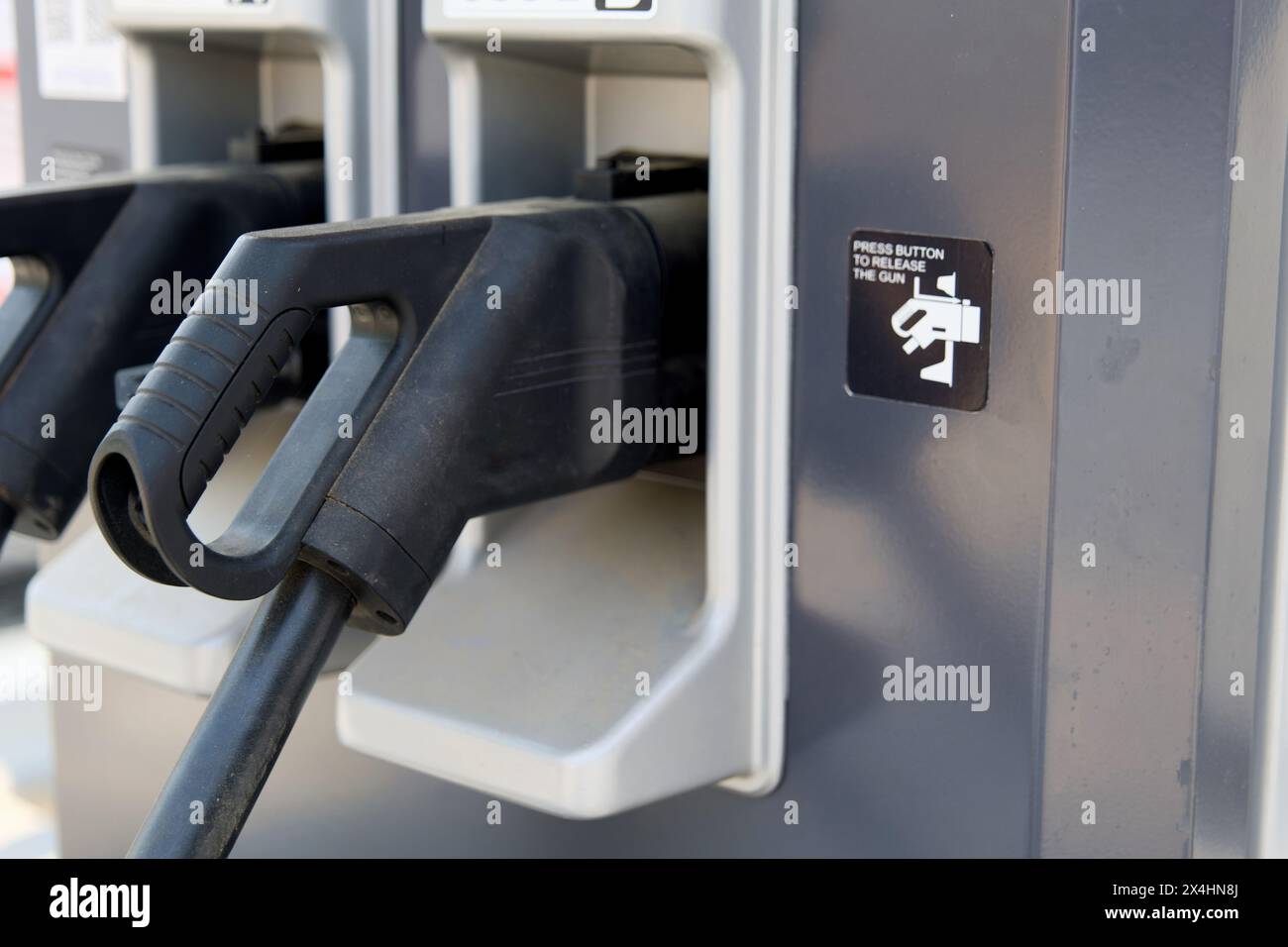 Close-up shot of a modern electric charging station at a gas station. This image represents the growing adoption of electric vehicles and the potentia Stock Photo