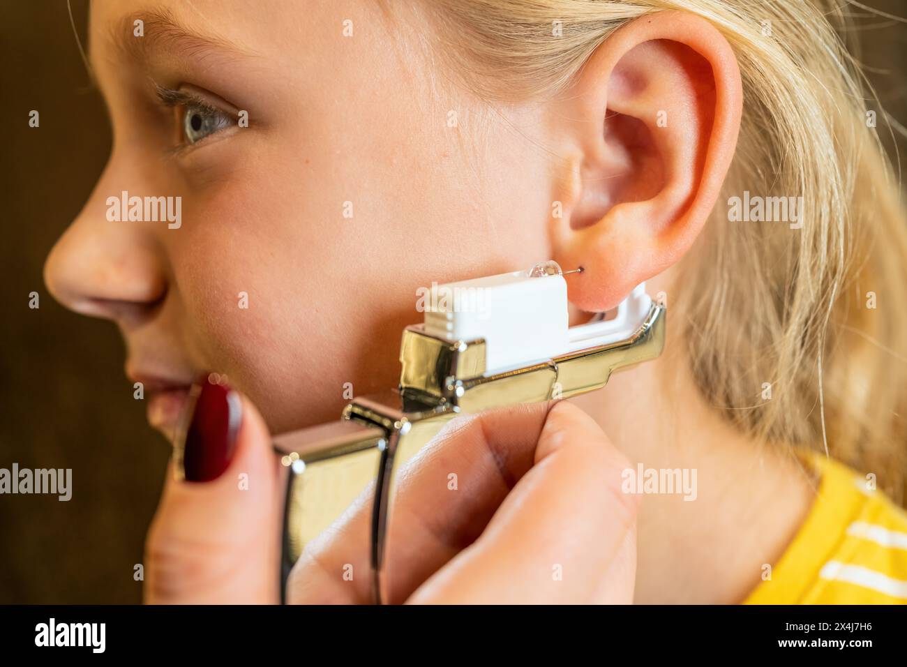 Ear piercing girl hires stock photography and images Alamy