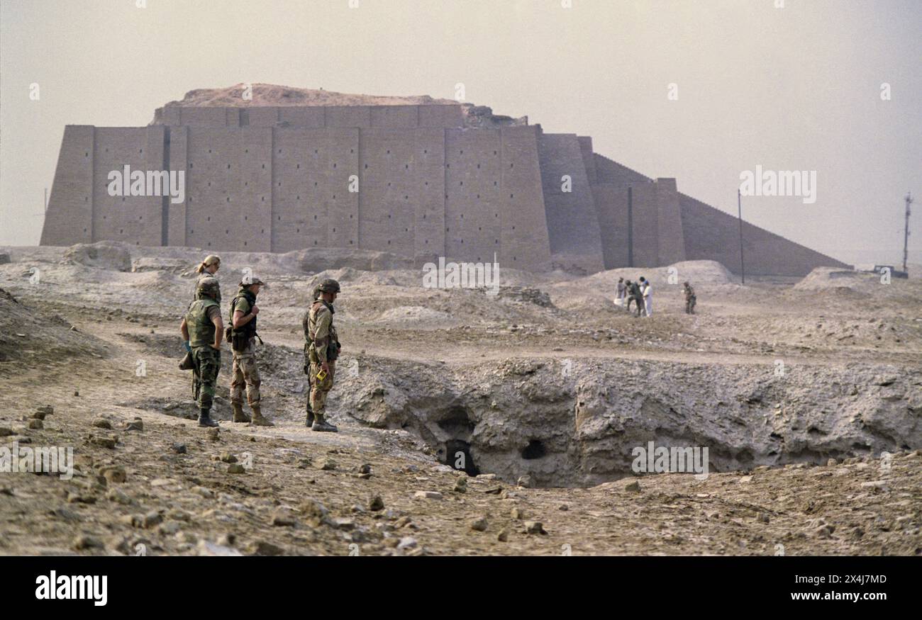 2nd April 1991 Coalition soldiers explore the ruins of the ancient Sumerian city of Ur in southern Iraq. In the background is the Great Ziggurat. Stock Photo