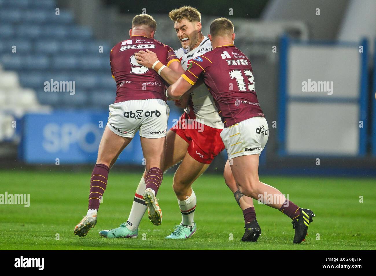Jack Ormondroyd of Salford Red Devils is tackled by Adam Milner of Huddersfield Giants and Luke Yates of Huddersfield Giants during the Betfred Super League Round 10 match Huddersfield Giants vs Salford Red Devils at John Smith's Stadium, Huddersfield, United Kingdom, 3rd May 2024  (Photo by Craig Thomas/News Images) Stock Photo