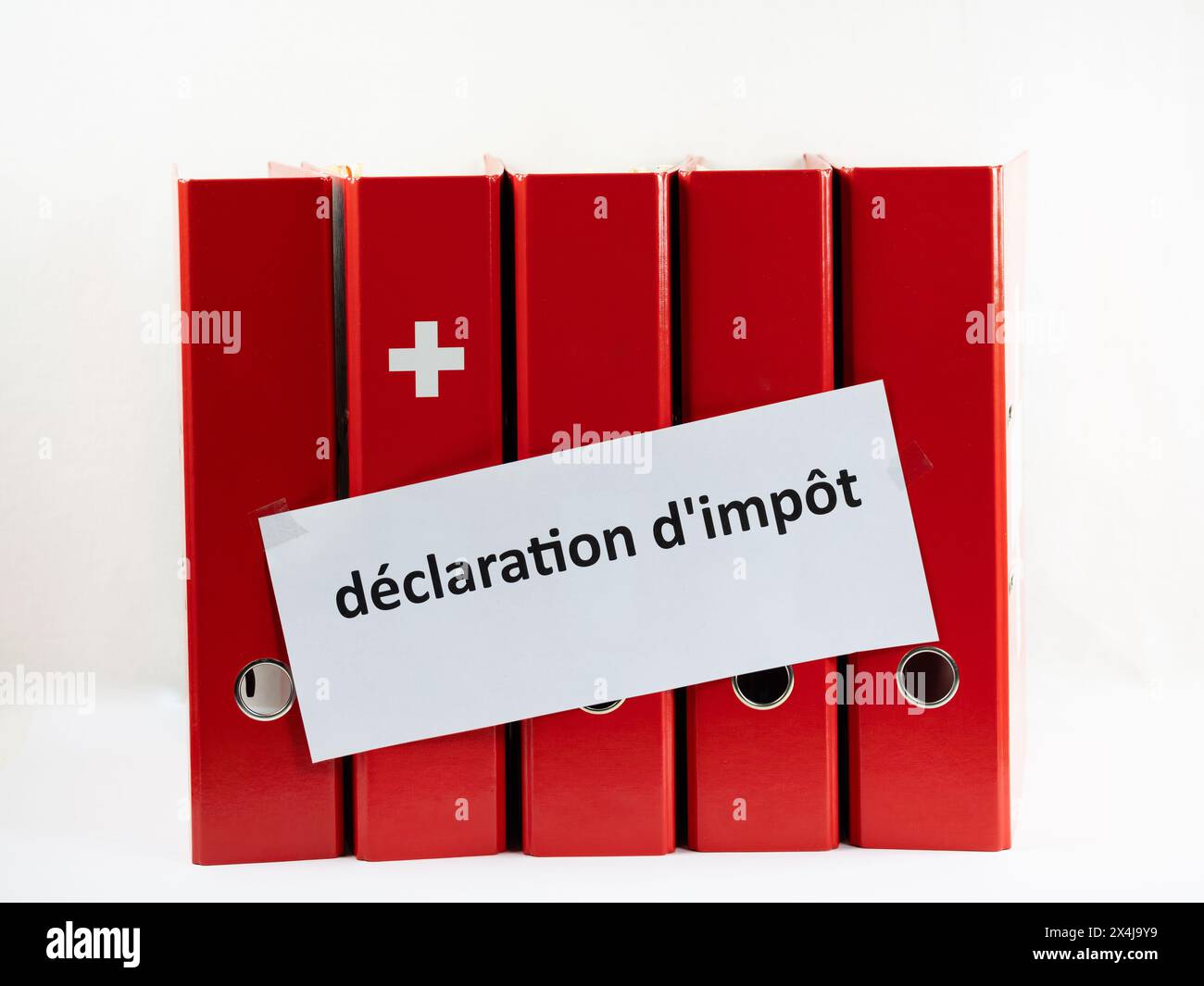 Concept for Swiss tax return. Office folders with Swiss flag symbol and french inscription in English translation: tax return Stock Photo