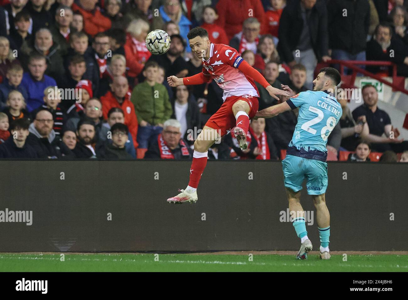 Jordan Williams of Barnsley jumps up to win the high ball during the Sky Bet League 1 Promotion Play-offs Semi-final first leg match Barnsley vs Bolton Wanderers at Oakwell, Barnsley, United Kingdom, 3rd May 2024  (Photo by Mark Cosgrove/News Images) Stock Photo