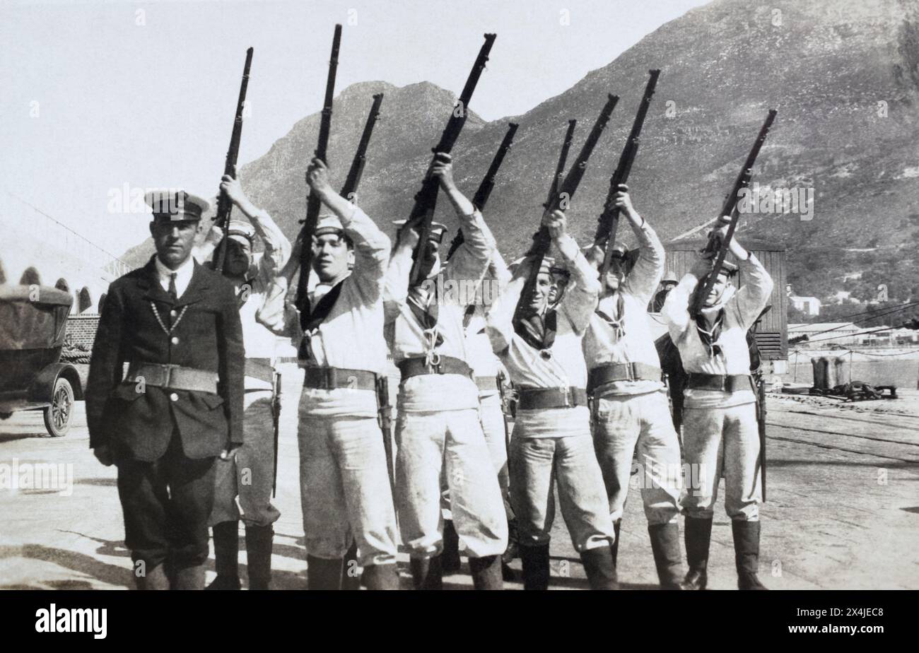 A Royal Navy shore party, believed to be from HMS Birmingham, posing with shart magazine Lee-Enfield rifles, c. 1920s. Stock Photo