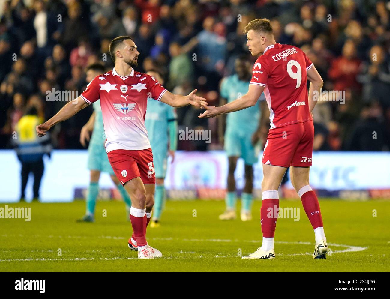 Barnsley's Sam Cosgrove (right) celebrates scoring their side's first goal of the game during the Sky Bet League One play-off, semi-final, first-leg match at Oakwell, Barnsley. Picture date: Friday May 3, 2024. Stock Photo