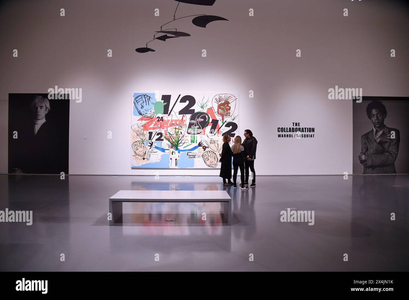 New York, USA. 03rd May, 2024. Visitors stands next to a collaborative painting between Andy Warhol and Jean-Michel Basquiat 'Untitled' estimated at $15M to $20M, on opening day of public exhibitions for Sotheby's marquee contemporary and Modern art auctions, New York, NY, May 3, 2024. (Photo by Anthony Behar/Sipa USA) Credit: Sipa USA/Alamy Live News Stock Photo