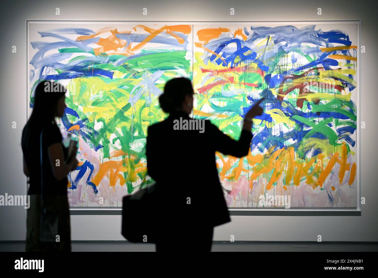 New York, USA. 03rd May, 2024. Two visitors stand in front of artist Joan Mitchell's painting titles 'Ground' - estimated at $15M to $20M - on opening day of public exhibitions for Sotheby's marquee contemporary and Modern art auctions, New York, NY, May 3, 2024. (Photo by Anthony Behar/Sipa USA) Credit: Sipa USA/Alamy Live News Stock Photo