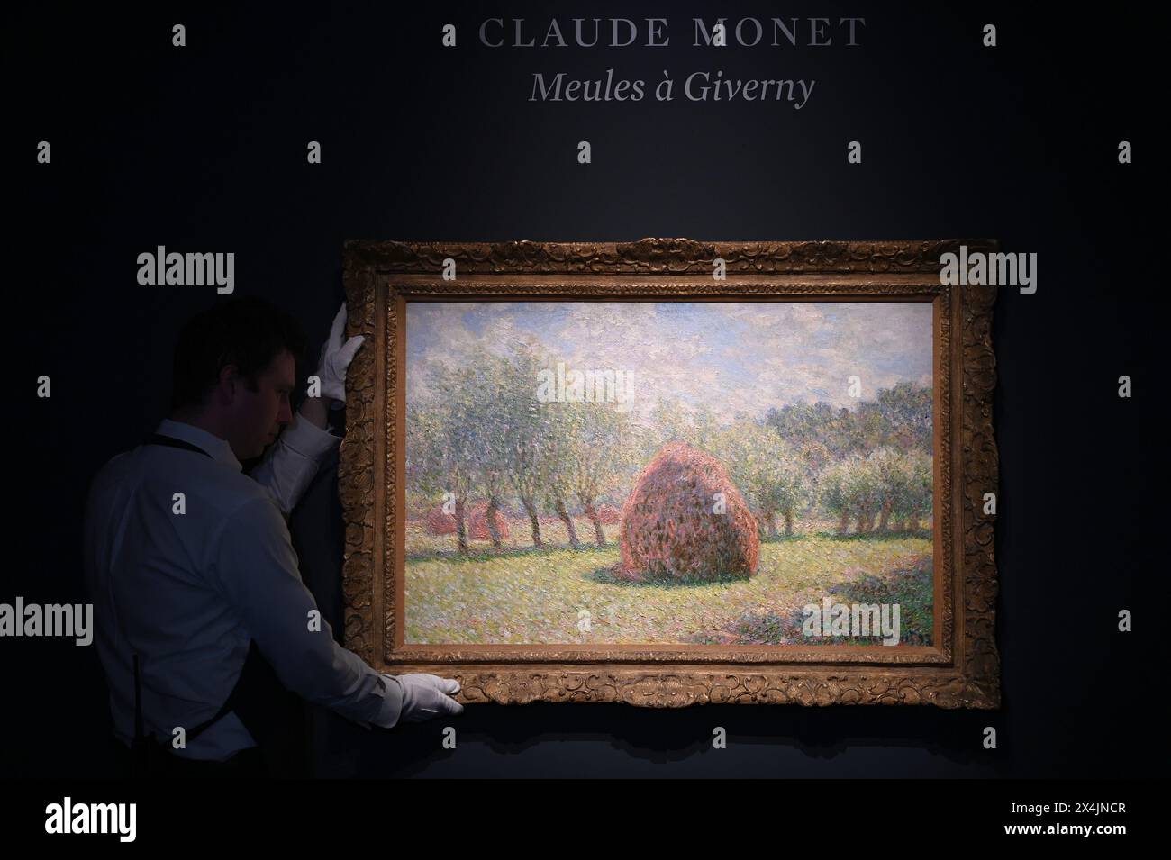 New York, USA. 03rd May, 2024. Art Handler Colin Rochstein holds a painting by French artist Claude Monet titled 'Meules a Giverny' - estimated at $30M - on opening day of public exhibitions for Sotheby's marquee contemporary and Modern art auctions, New York, NY, May 3, 2024. (Photo by Anthony Behar/Sipa USA) Credit: Sipa USA/Alamy Live News Stock Photo
