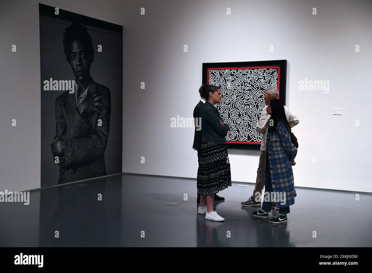 New York, USA. 03rd May, 2024. Visitors stand near an untitled piece by artist Keith Haring - estimated $4M to $6M - on opening day of public exhibitions for Sotheby's marquee contemporary and Modern art auctions, New York, NY, May 3, 2024. (Photo by Anthony Behar/Sipa USA) Credit: Sipa USA/Alamy Live News Stock Photo