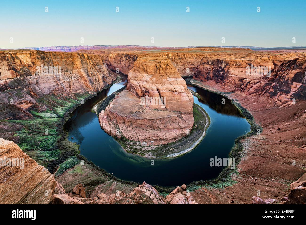 Super panorama of Horseshoe Bend in Page Arizona shows the pink inversion layer and the dramatic horseshoe shape from which the Colorado River flows. Stock Photo
