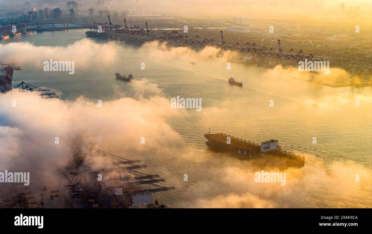 QINGDAO, CHINA - MAY 3, 2024 - Large container ships enter and exit the ...
