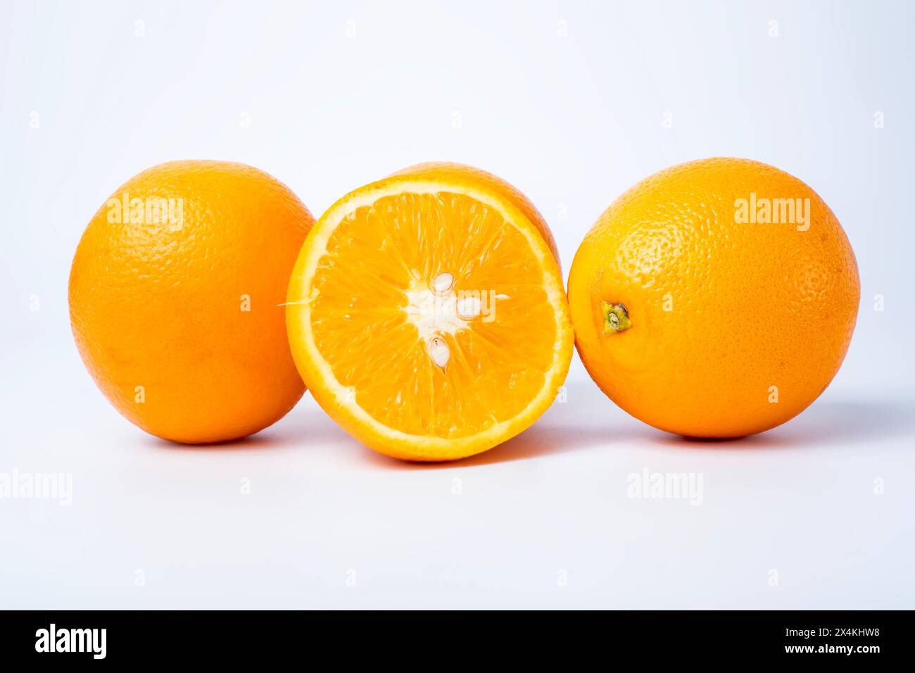 Ripe oranges isolated on white background with clipping path. Fresh orange fruit. Stock Photo