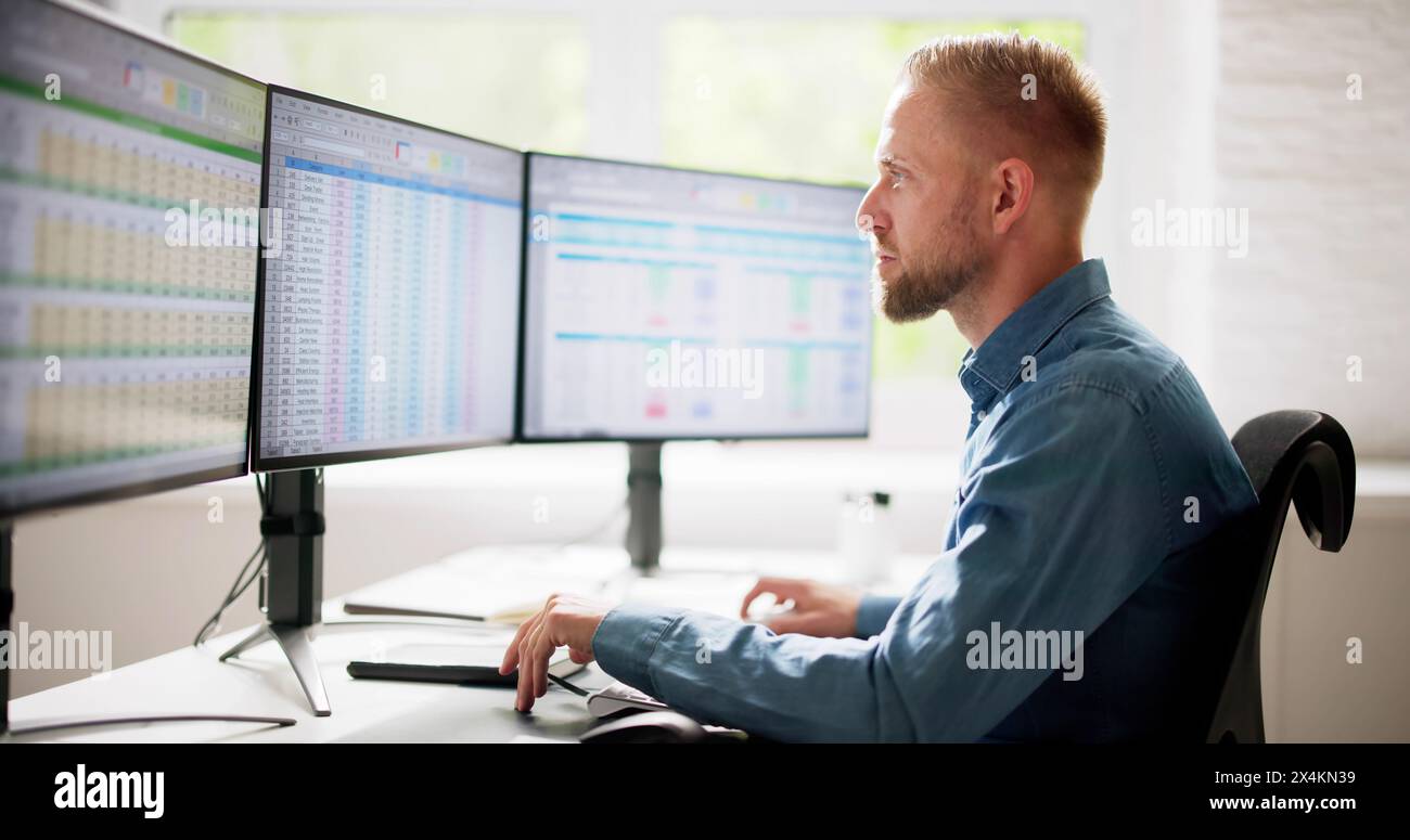 Data Analyst Man Using Spreadsheet On Computer Stock Photo