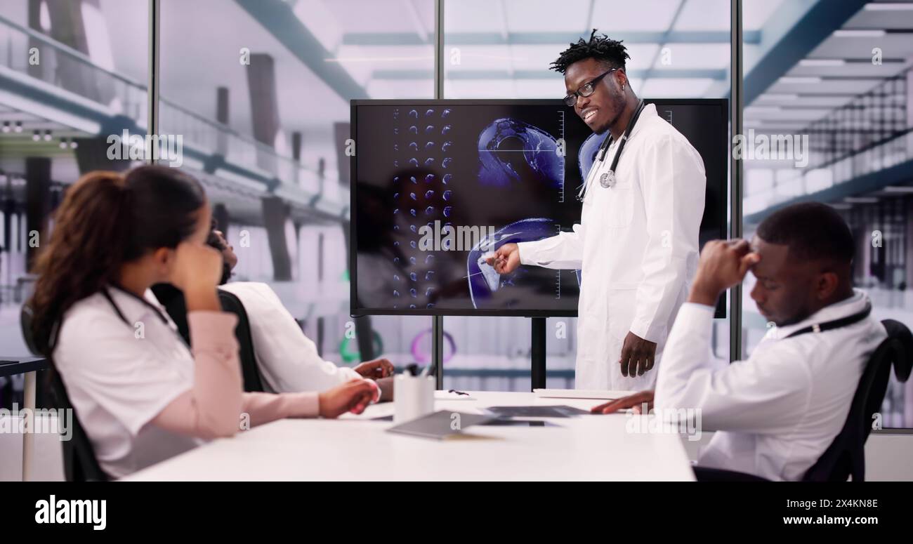 Physician Looking At Shoulder MRT Scan Caucasian Stock Photo