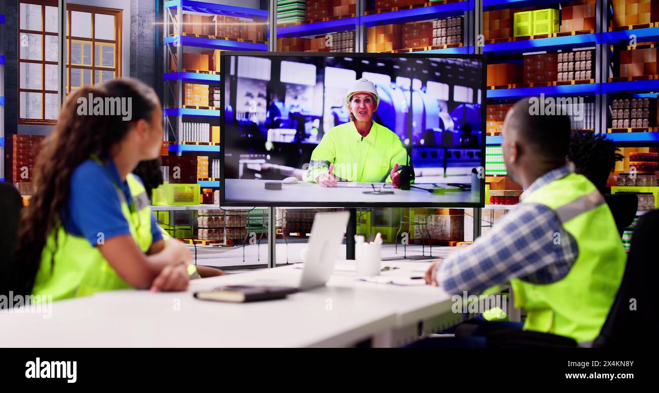 Warehouse Workers Having Video Conference With Woman Stock Photo