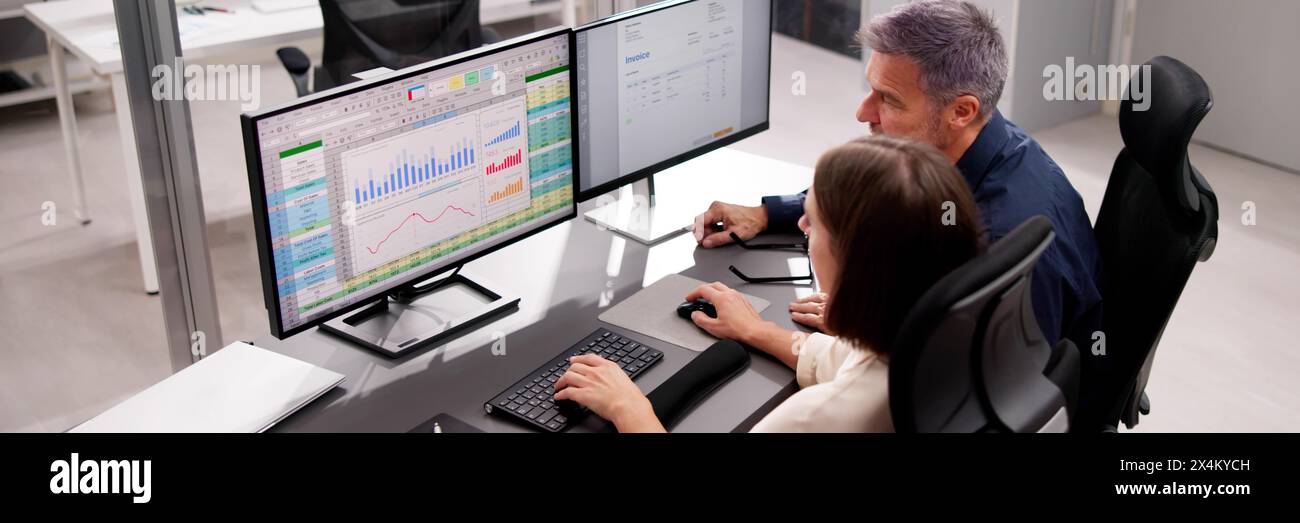 Multiple medical coders working on computer spreadsheets. Stock Photo