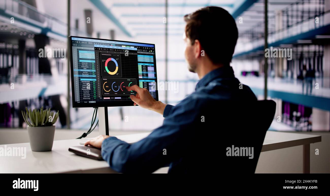 Spreadsheet Analyst Employee Using Computer Monitors For Analysis Stock Photo