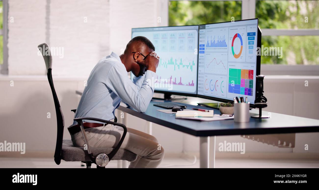 Data Analyst African Man Using Spreadsheet On Computer Stock Photo