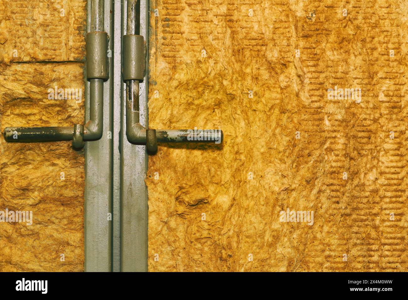 Metal deadbolt on a door or gate covered with wooden cardboard Stock Photo