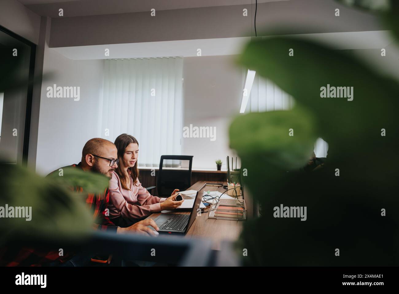 Business professionals collaborating on a project in a modern office ...
