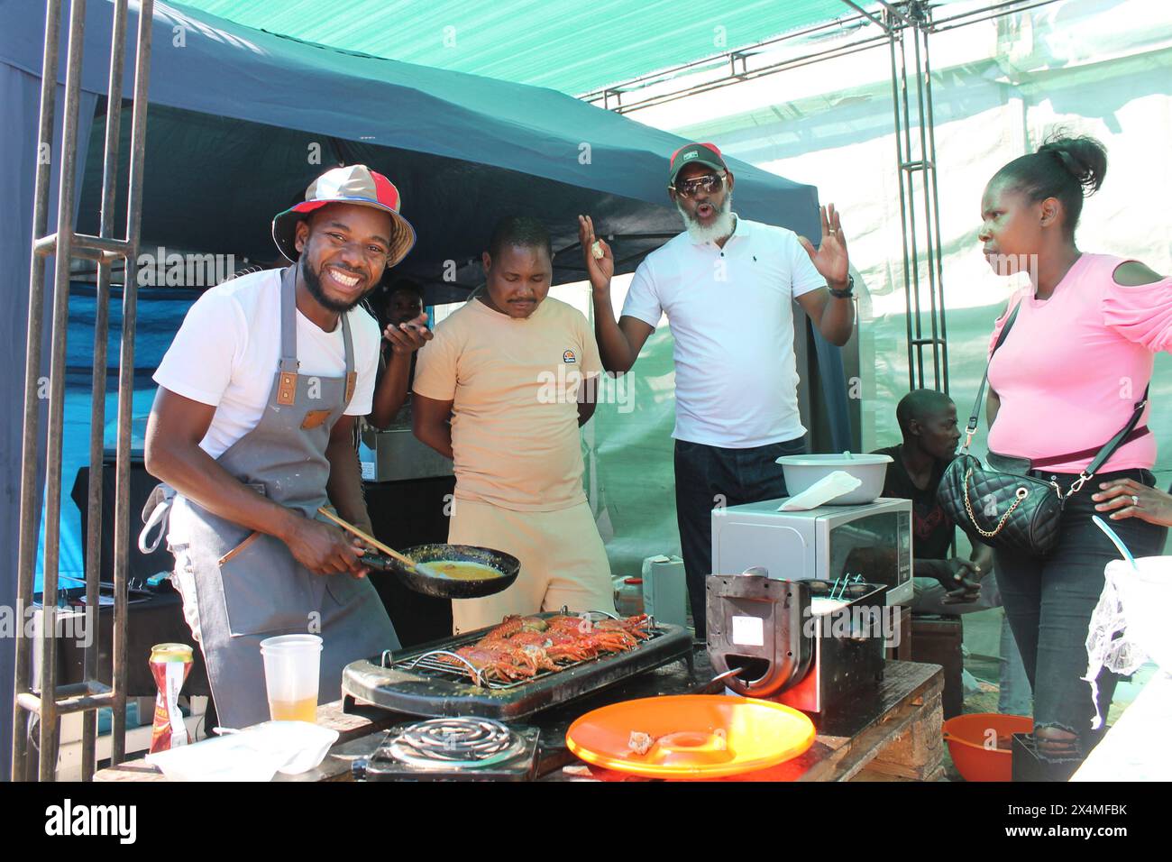 Luderitz, Namibia. 3rd May, 2024. A trader sells seafood during the annual crayfish festival held in the southern town of Luderitz, Namibia, May 3, 2024. TO GO WITH 'Namibia's annual crayfish festival boosts economic growth, says VP' Credit: Ndalimpinga Iita/Xinhua/Alamy Live News Stock Photo